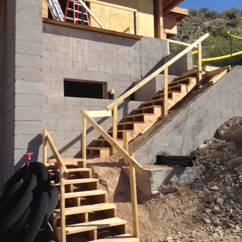 Temporary construction stairs are built from the motor court level to the main level.