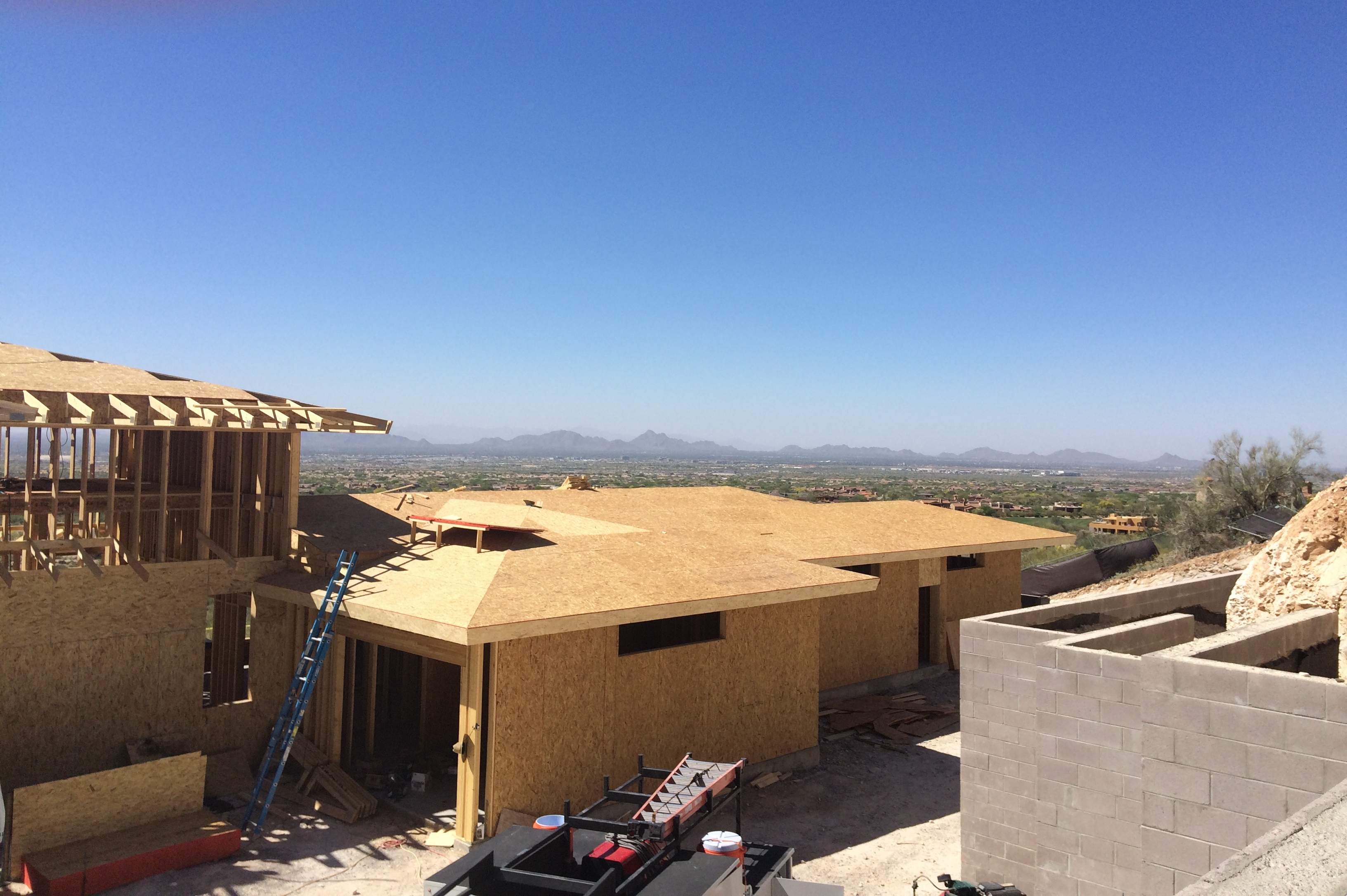 Atop a masonry retaining wall, we can see the vast views over the framed garage.