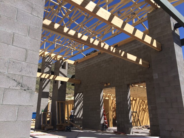 This ground view shows the towering masonry framing with the trusses in place.