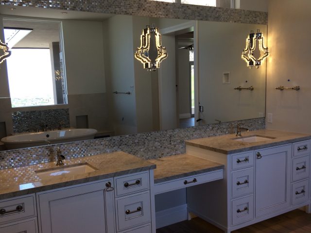 Elegant lighting in the mirrors illuminates the double-sink vanity.